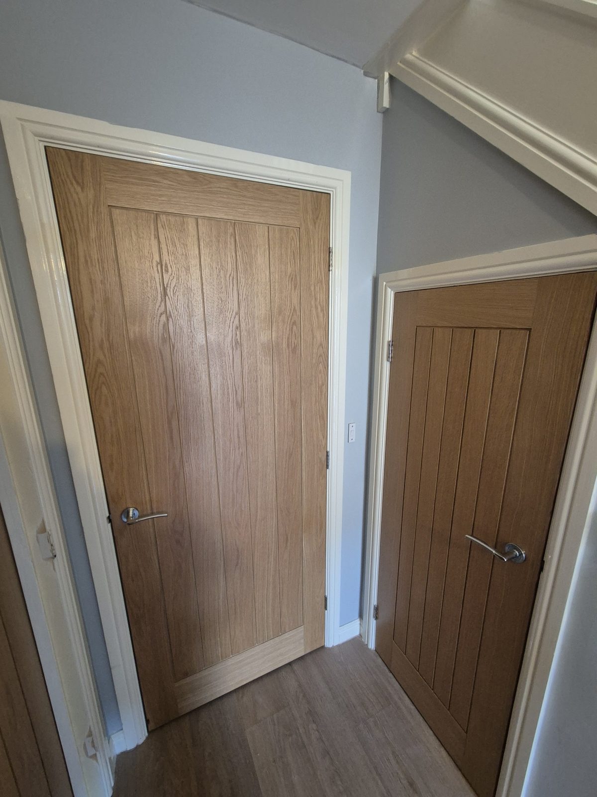 Two oak cottage-style interior doors hung on a landing